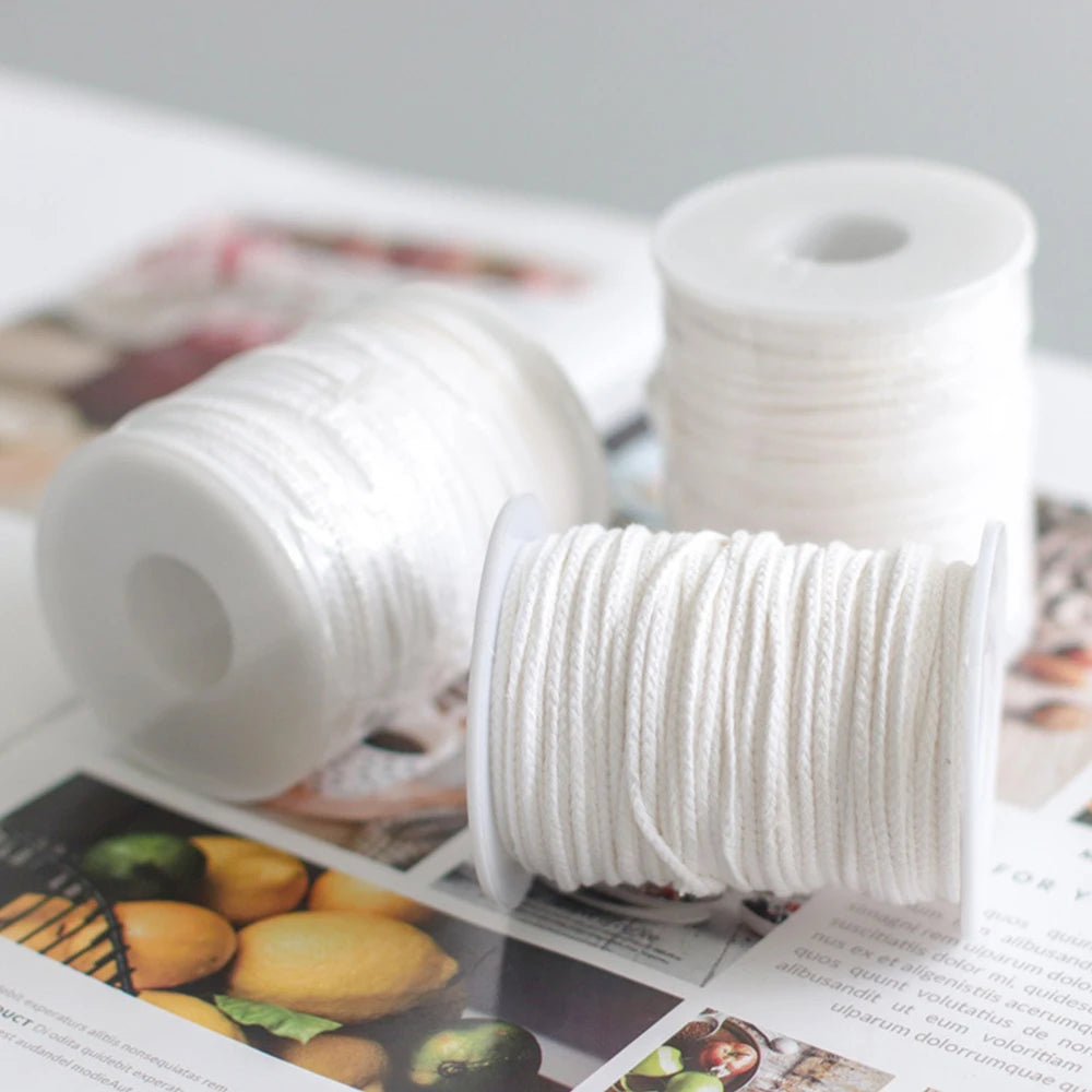 White braided cotton candle wicks displayed on spools and packaging.