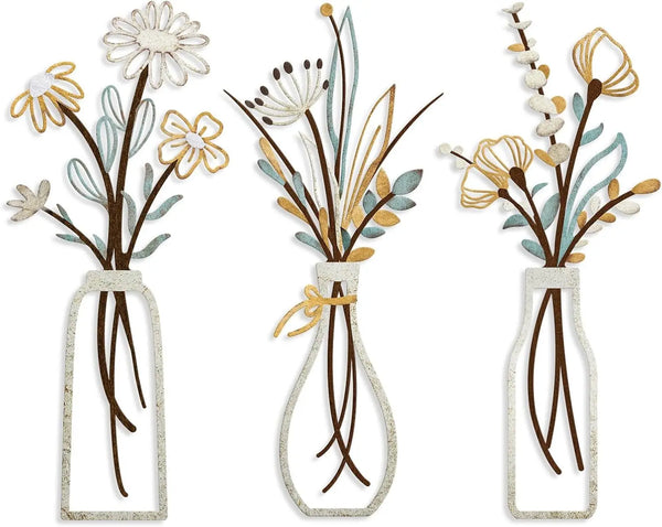 Set of three rustic metal flower arrangements in glass bottles with dried flowers and greenery
