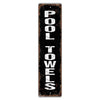 Vintage metal sign with the text POOL TOWELS in distressed white lettering on a black background