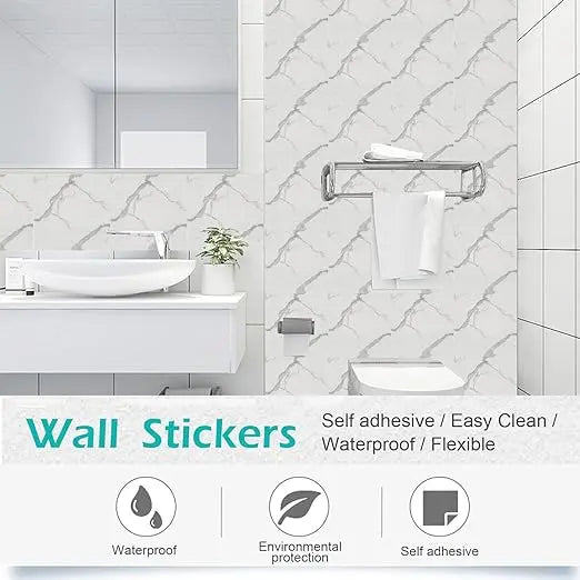White ceramic sink and countertop with a modern faucet set against a white tiled wall backdrop.