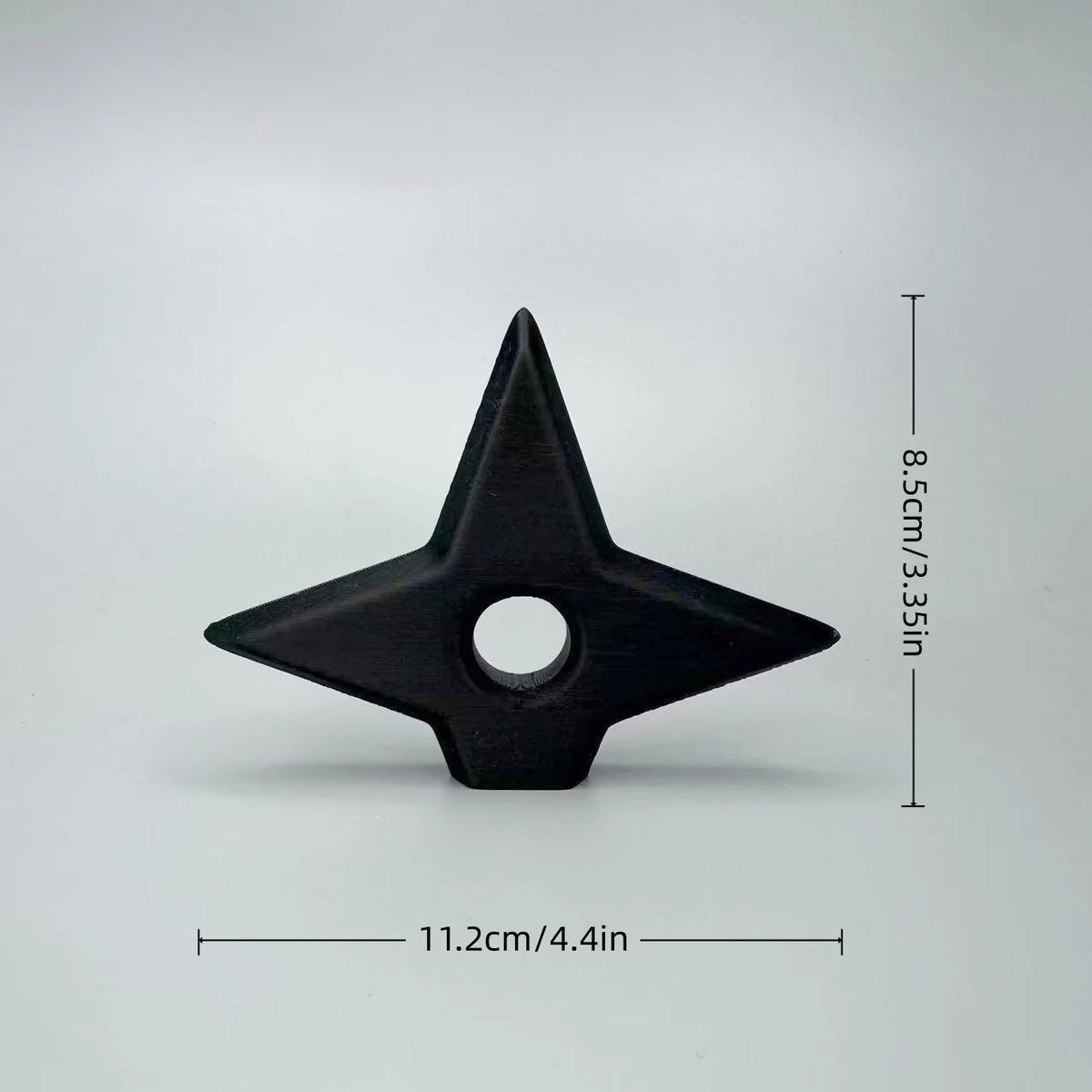Black triangular ornament with a central hole, measuring 11.2 cm long and 8.5 cm high.