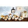A collection of handcrafted miniature mushroom tableware, including teapots and cups, displayed against a blue floral backgro