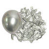 A silver metallic balloon is shown next to a pile of crumpled silver foil balloons for party décor.
