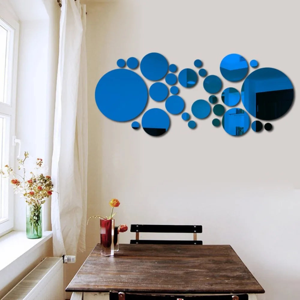 Abstract blue and black circular mirror decals displayed on a wall above a wooden table.