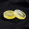 Two polished yellow citrine crystals resting on a dark surface.