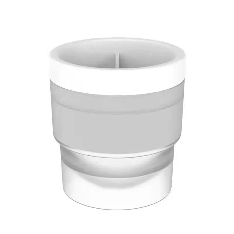 A white stackable spherical ice mold for whiskey and cocktails.