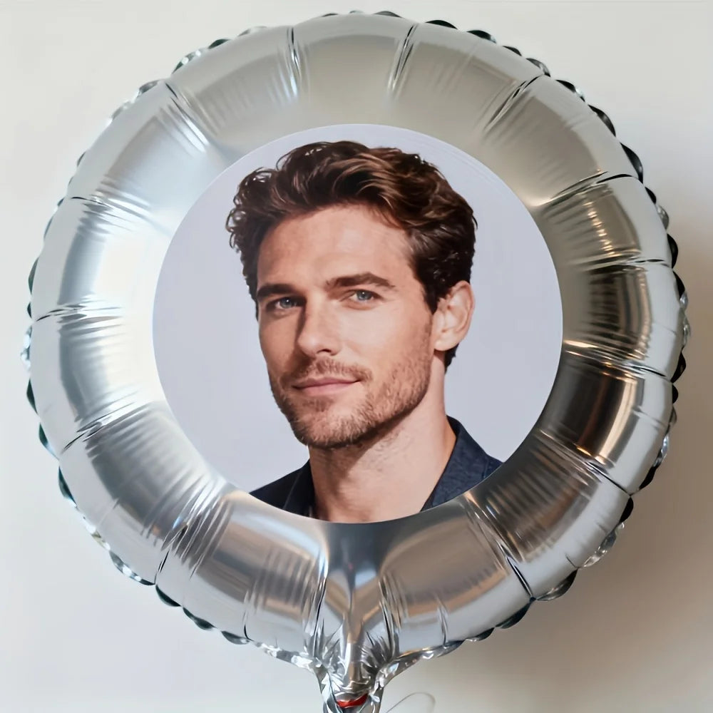 A silver foil balloon shaped like a circle, featuring a portrait of a man.
