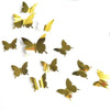 A set of twelve gold mirror effect butterfly wall stickers scattered on a white background.
