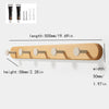 A wooden wall hook rack with four hooks made of solid beech wood.