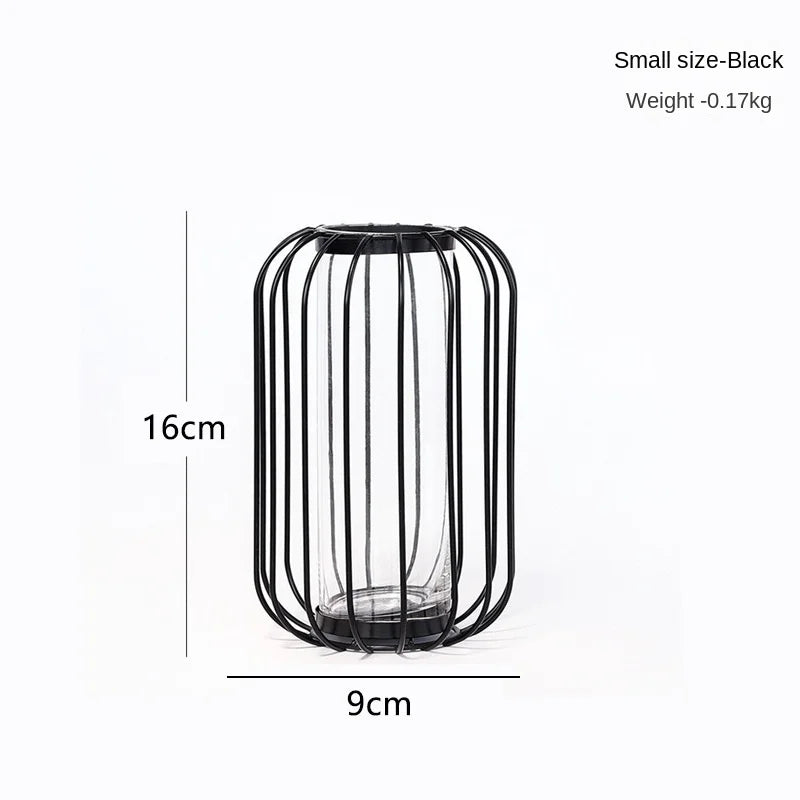 Small black iron hollow vase with vertical slats, measuring 16cm high and 9cm wide.