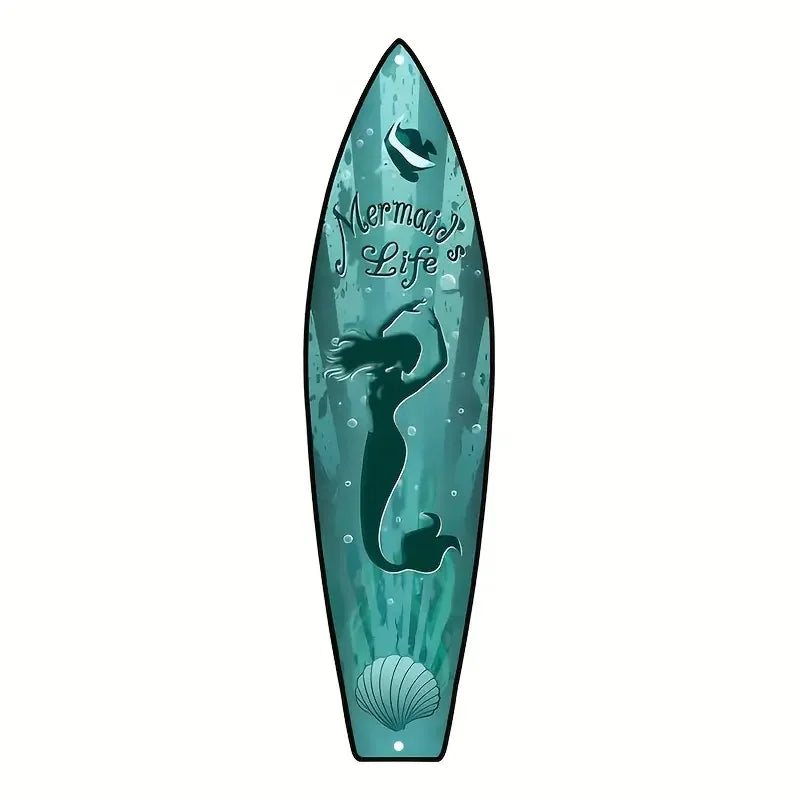 A vertical wooden wall decor sign shaped like a surfboard featuring a mermaid silhouette and a seashell design in teal.