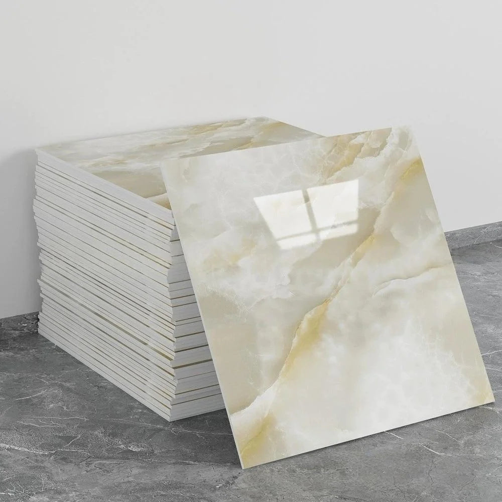 A stack of self-adhesive marble tile stickers featuring a light beige and white veined pattern.