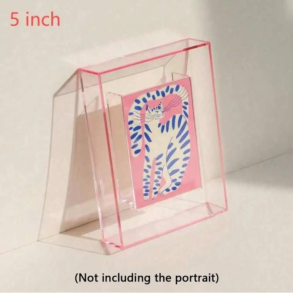A clear acrylic photo frame with a pink border holds a colorful cat portrait inside.
