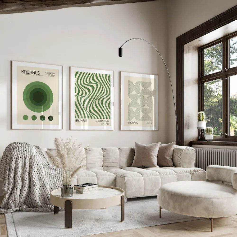 A set of three framed Bauhaus art prints featuring green and beige geometric patterns displayed on a white wall.