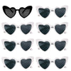 A set of heart-shaped sunglasses with black lenses and white frames.