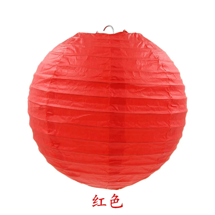 A bright red, round paper lantern used for parties and weddings.