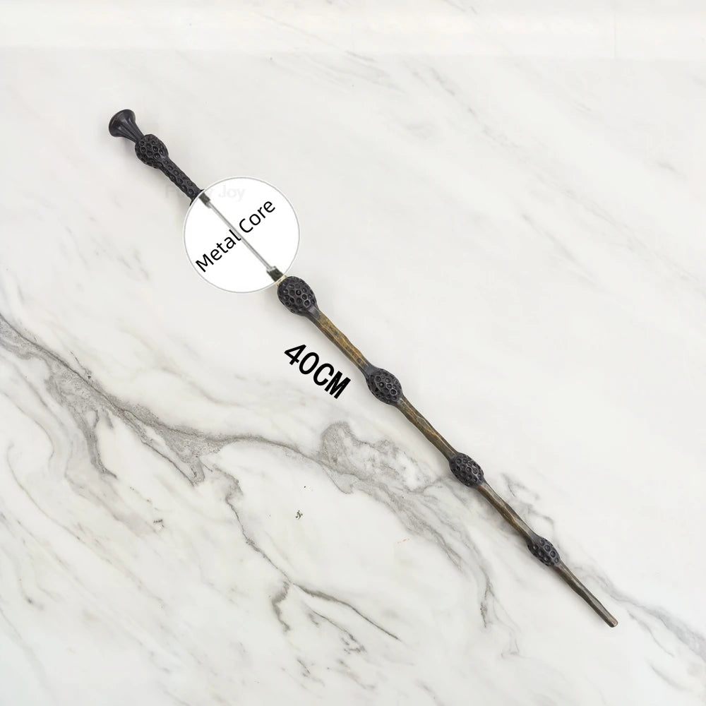 A long, slender metal wand replica with a textured handle and a metal core, shown against a white marble background.