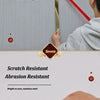 A hand applies a thin, black strip of stainless steel trim to a surface.