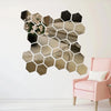A decorative wall mirror featuring a honeycomb pattern made of small, reflective hexagons.