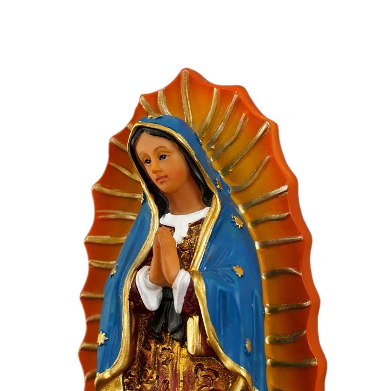 Hand-painted resin statue of Our Lady of Guadalupe with a blue mantle and orange sunburst background