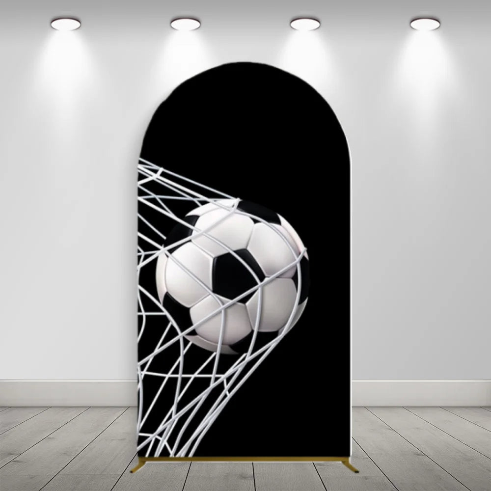 A black soccer football is displayed through a white mesh arch backdrop for a photo booth.