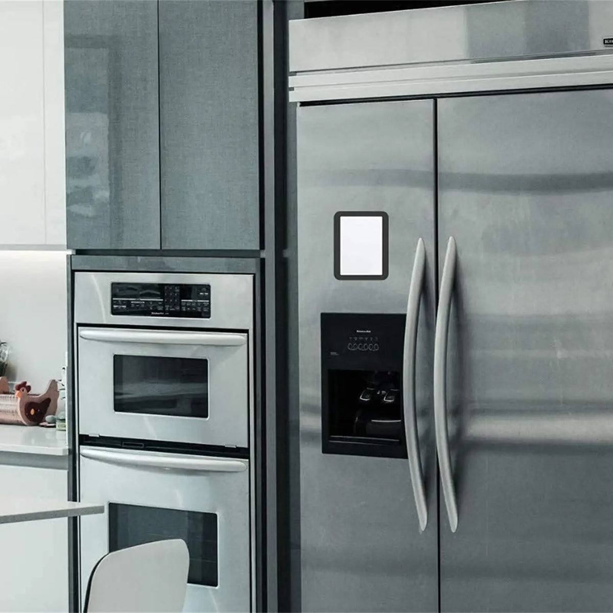 A stainless steel refrigerator featuring a compact magnetic locker mirror and door handles.