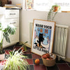 A framed poster depicting a cat washing its paws in a bathtub for kids' bathroom decor