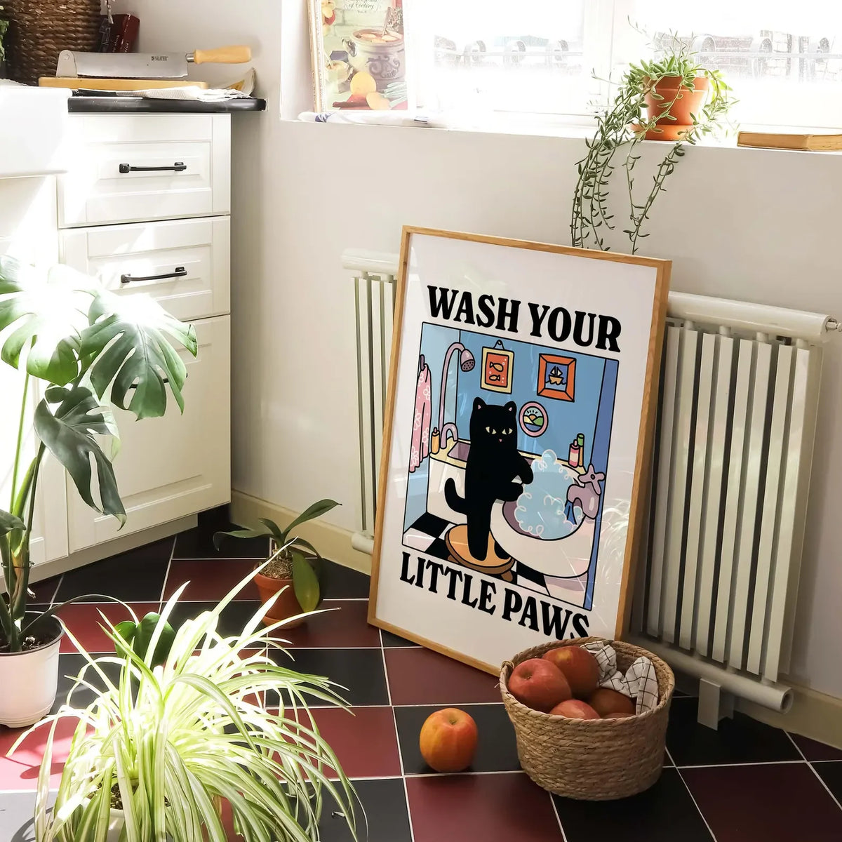 A framed poster depicting a cat washing its paws in a bathtub for kids' bathroom decor