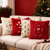 A collection of red and white candy cane shaped Christmas pillows displayed on a light sofa.
