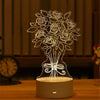 A glowing acrylic LED night light shaped like a bouquet of roses sits on a wooden surface.