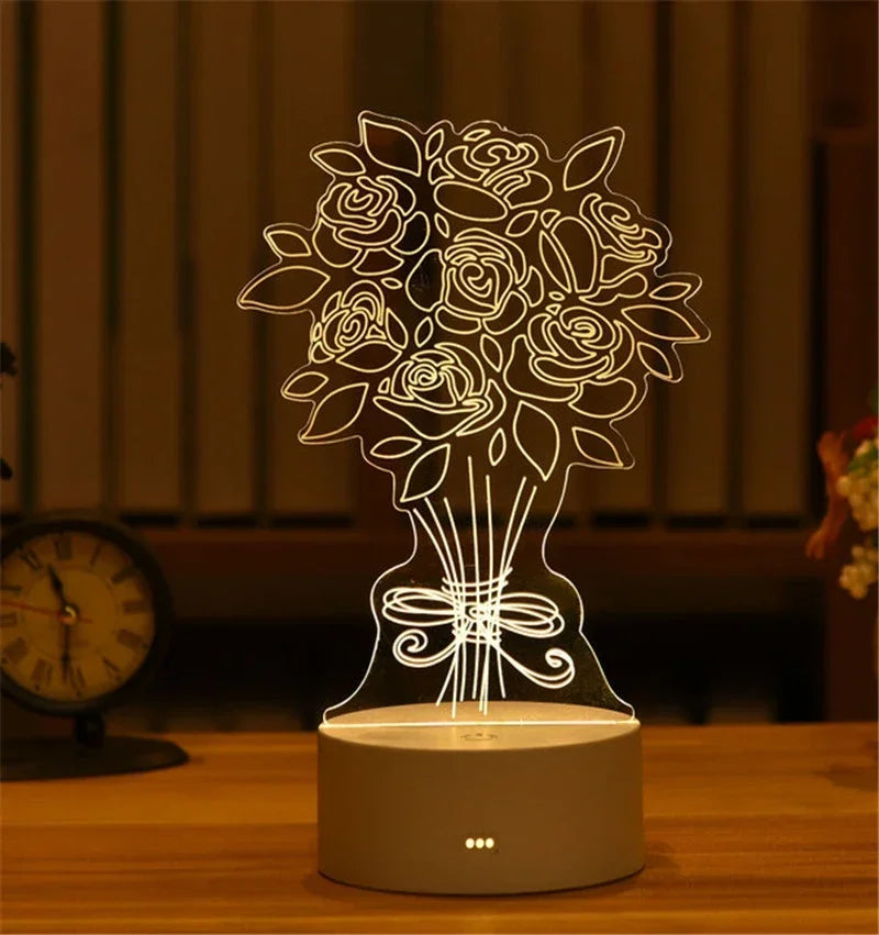 A glowing acrylic LED night light shaped like a bouquet of roses sits on a wooden surface.