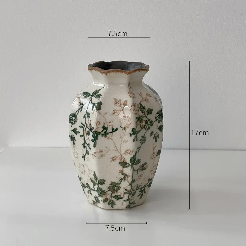 A rustic ceramic milk pitcher with a cracked glaze and pastoral floral design, shown against a white background.