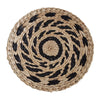 Round woven straw wall decor hanging with black and natural beige stripes