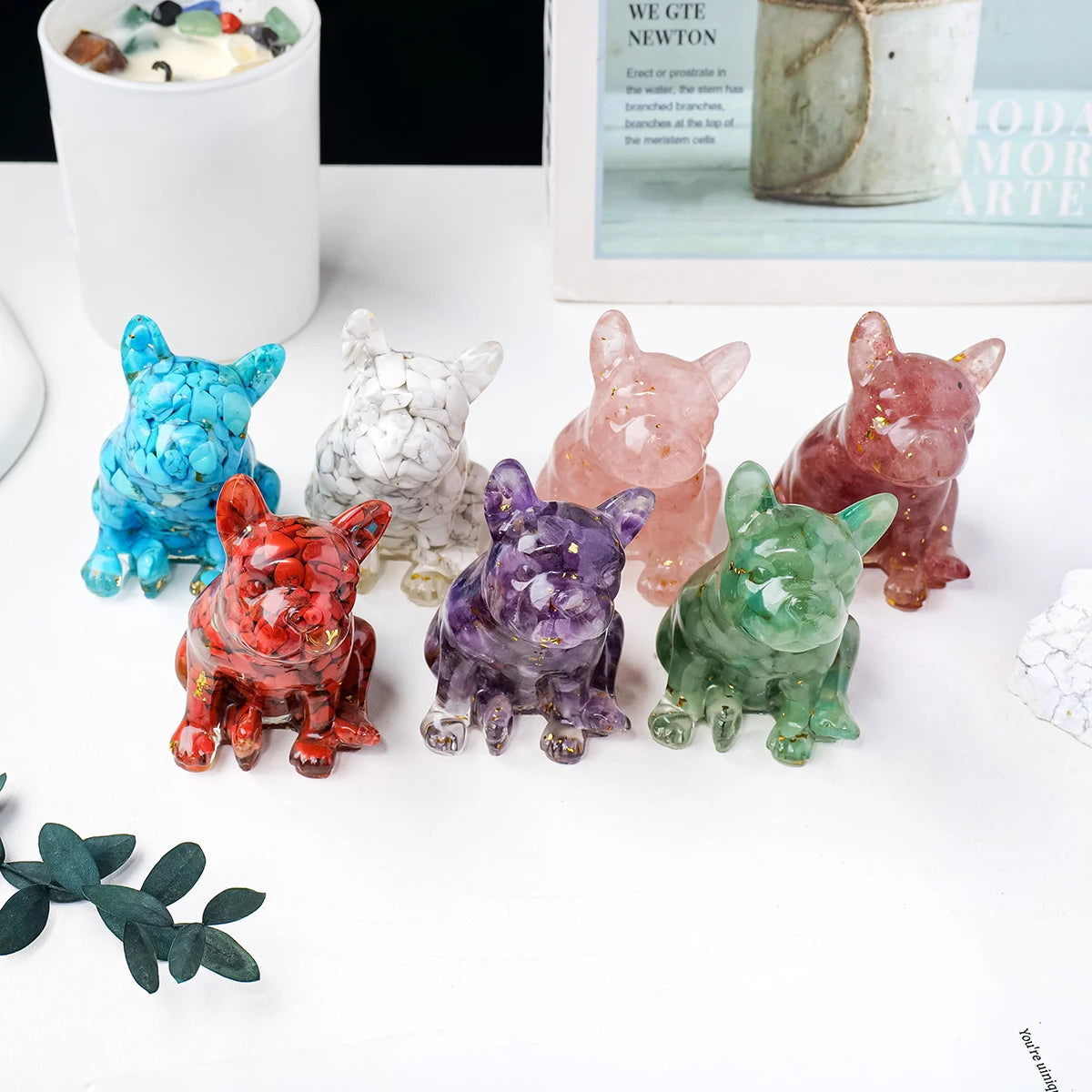 A collection of natural crystal dog statues in various colors and textures displayed on a white surface.