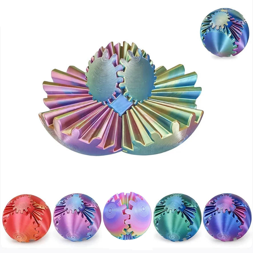A collection of colorful 3D printed gear balls or fidget spinners in various iridescent and metallic finishes.