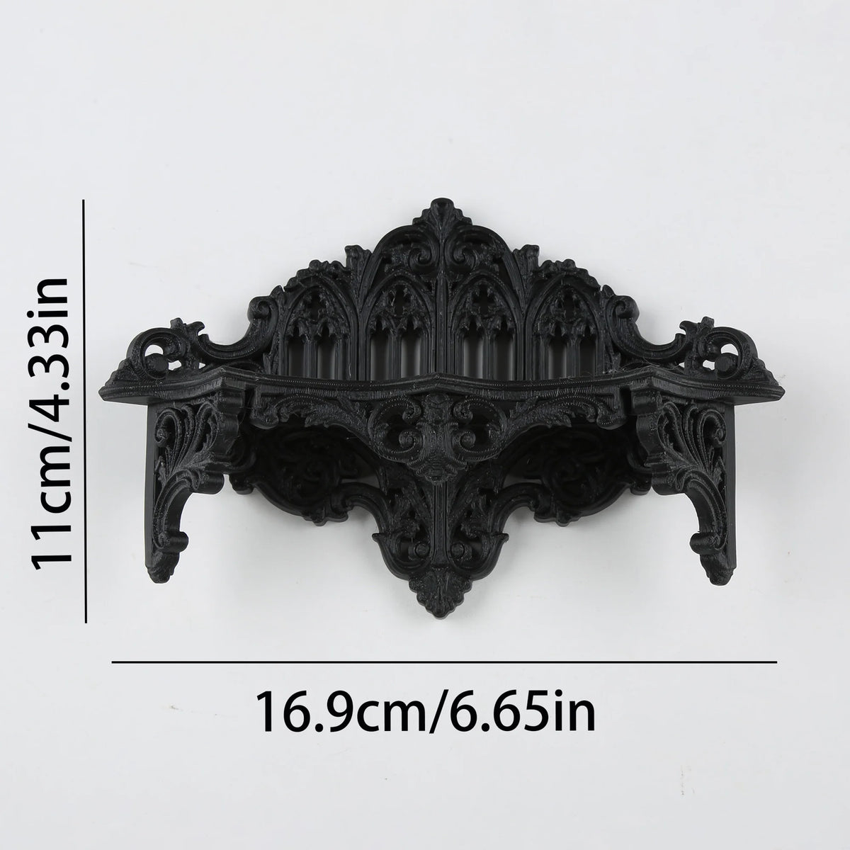 Black ornate Gothic wall shelf featuring intricate carvings and decorative molding.