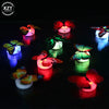 A collection of glowing 3D LED butterfly wall night lights floating on dark water.