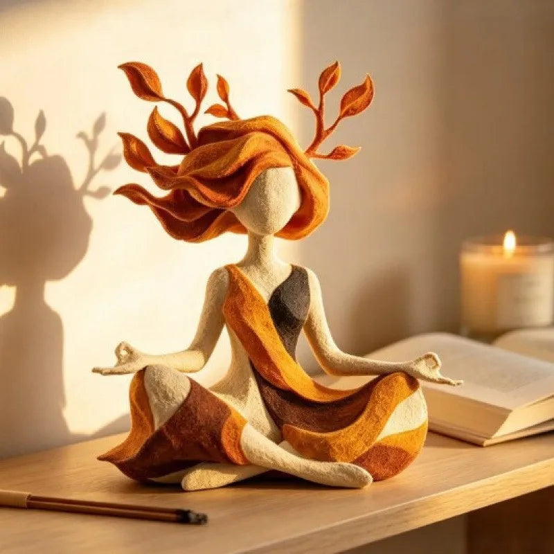 A resin sculpture of a yoga girl with orange hair and antlers sitting on a wooden surface.