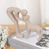 A beige sculpture depicting a human and a dog embracing, shown in a side profile.