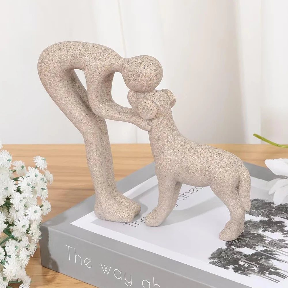 A beige sculpture depicting a human and a dog embracing, shown in a side profile.