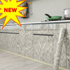 A kitchen cabinet featuring marble-patterned doors and a light wood floor.