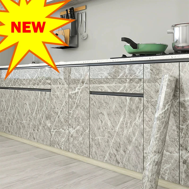 A kitchen cabinet featuring marble-patterned doors and a light wood floor.