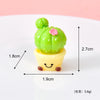 A small green cactus resin charm with a pink flower, potted in a yellow base, shown against a white background.