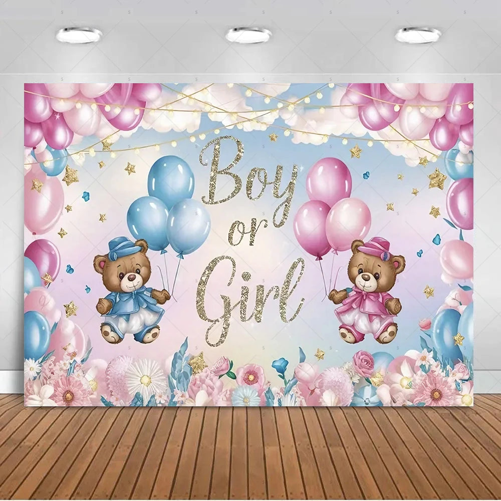 A pink and blue gender reveal backdrop featuring balloons, gold lettering, and teddy bears against a soft sky background.