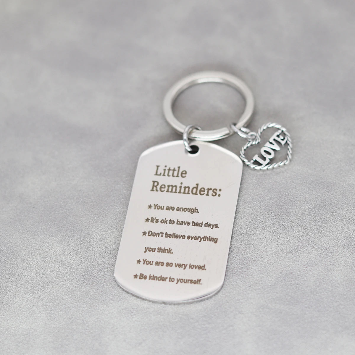 Silver stainless steel inspirational heart keychain tag with text reminders engraved on it