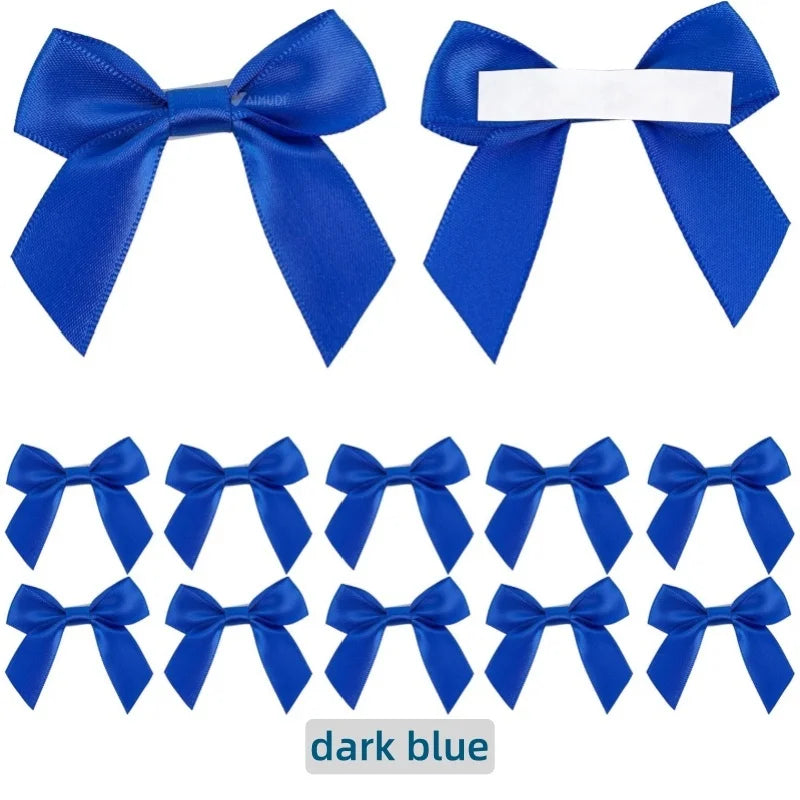 A collection of dark blue satin ribbon bows with white adhesive backing for crafting and gift wrapping.