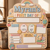 A personalized wooden sign for a first day of school featuring a rainbow and various decorative elements.