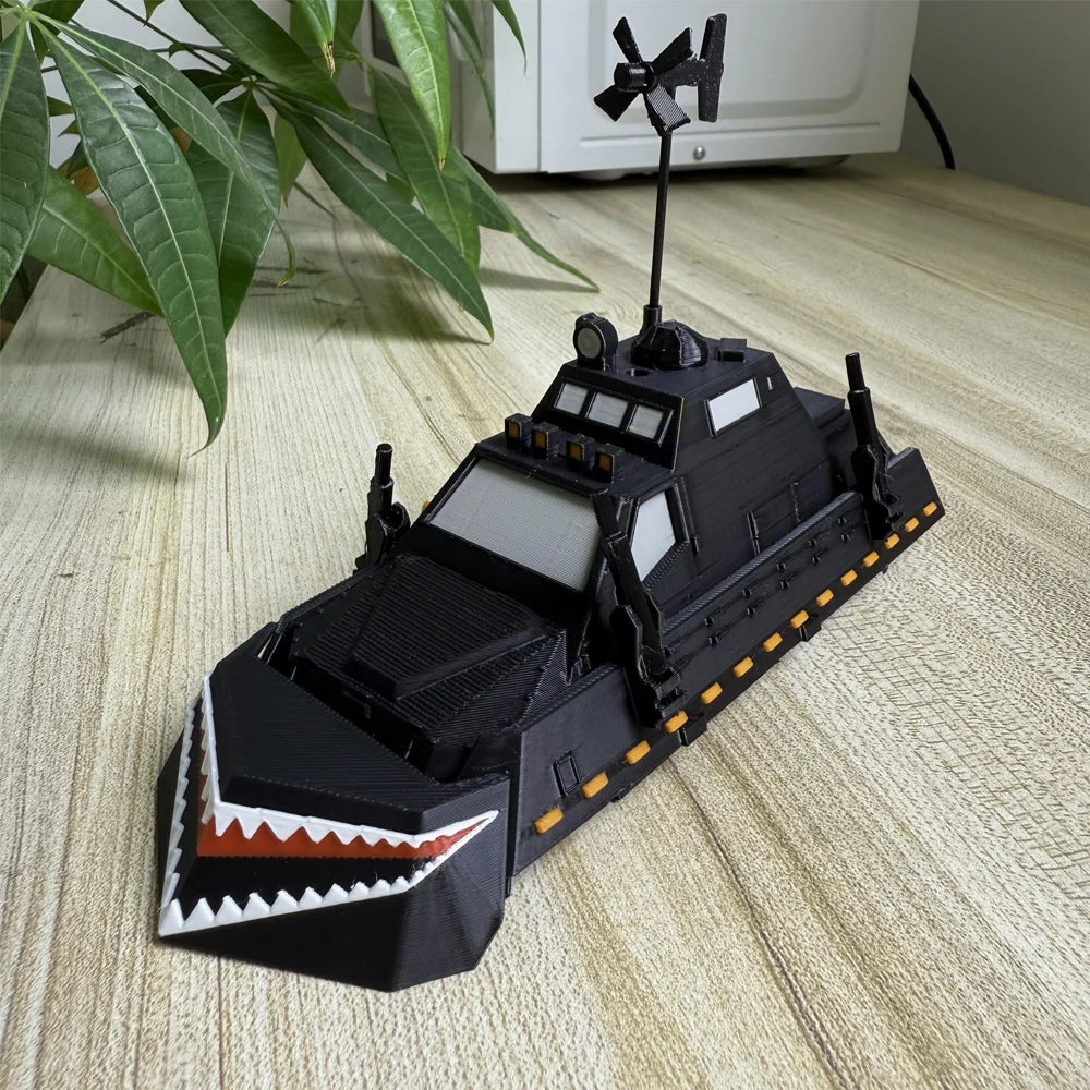 A black armored car model resembling a Storm Chaser Tornado Interceptor displayed on a wooden surface.