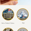 Embossed metal fridge magnet featuring a scenic view of Switzerland, including the Federal Palace, Alps, Lion Monument, Gross