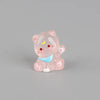 A small, pink, translucent resin cat keychain with a blue accent, featuring glitter and facial details.